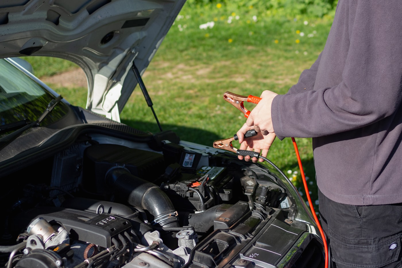 Mechanic using a handheld scan tool on a car