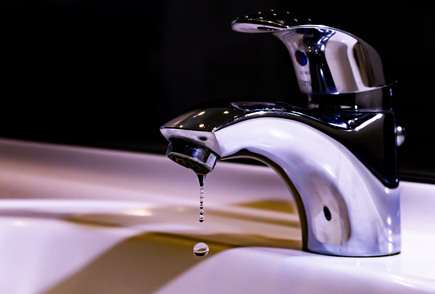 Close-up of a leaky faucet dripping water