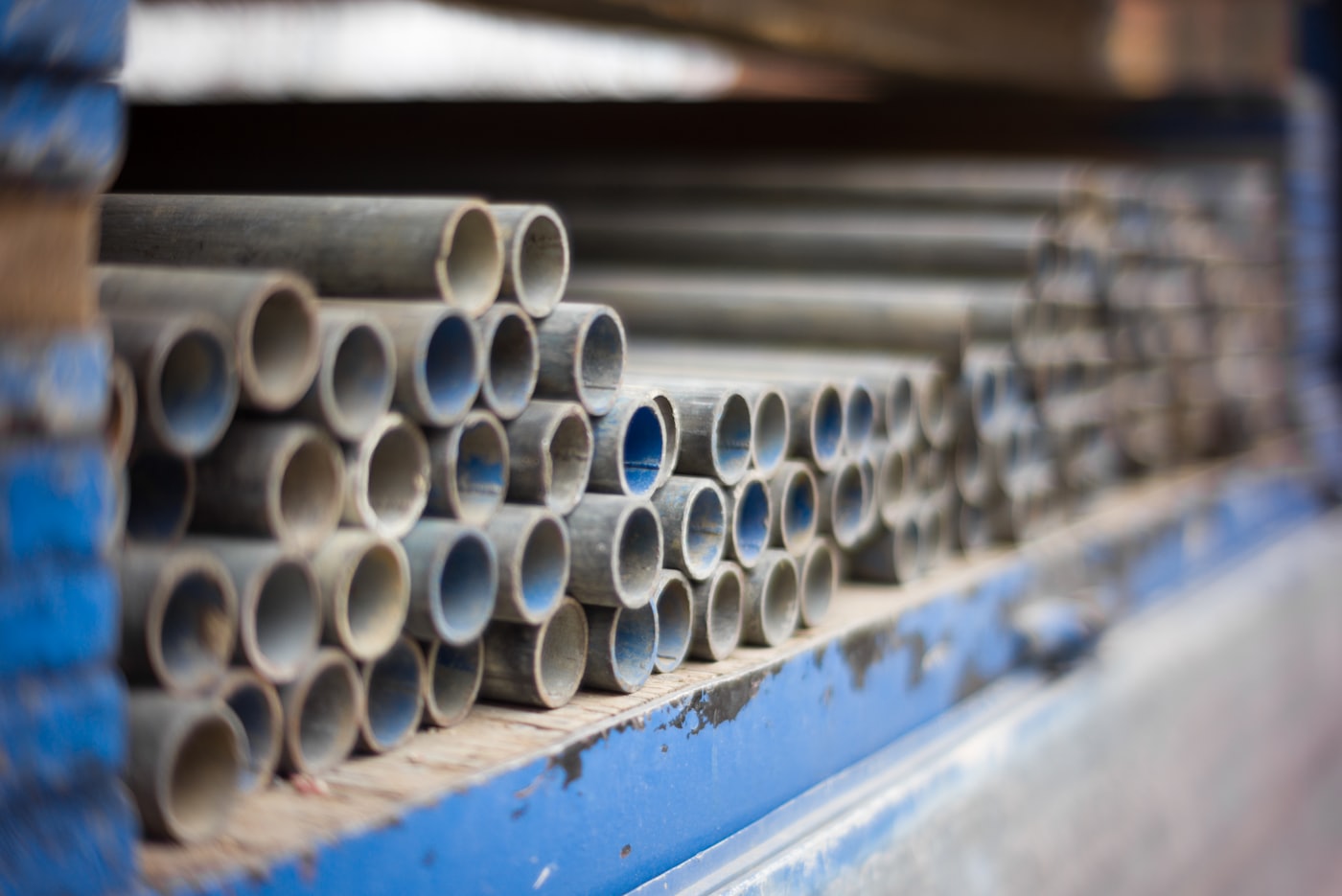 Stacks of new metal plumbing pipes ready for install