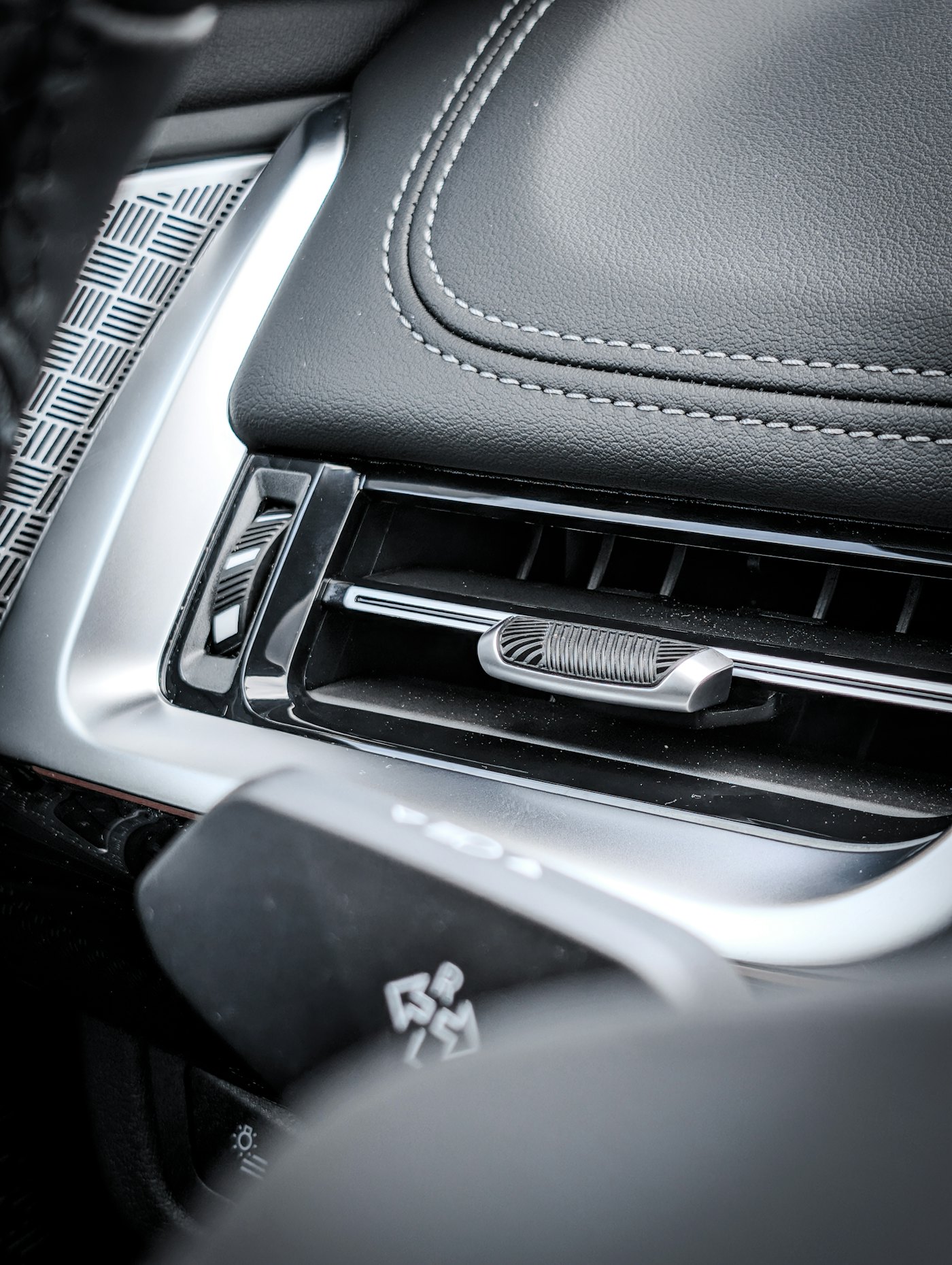 Close-up of a car AC vent and dashboard