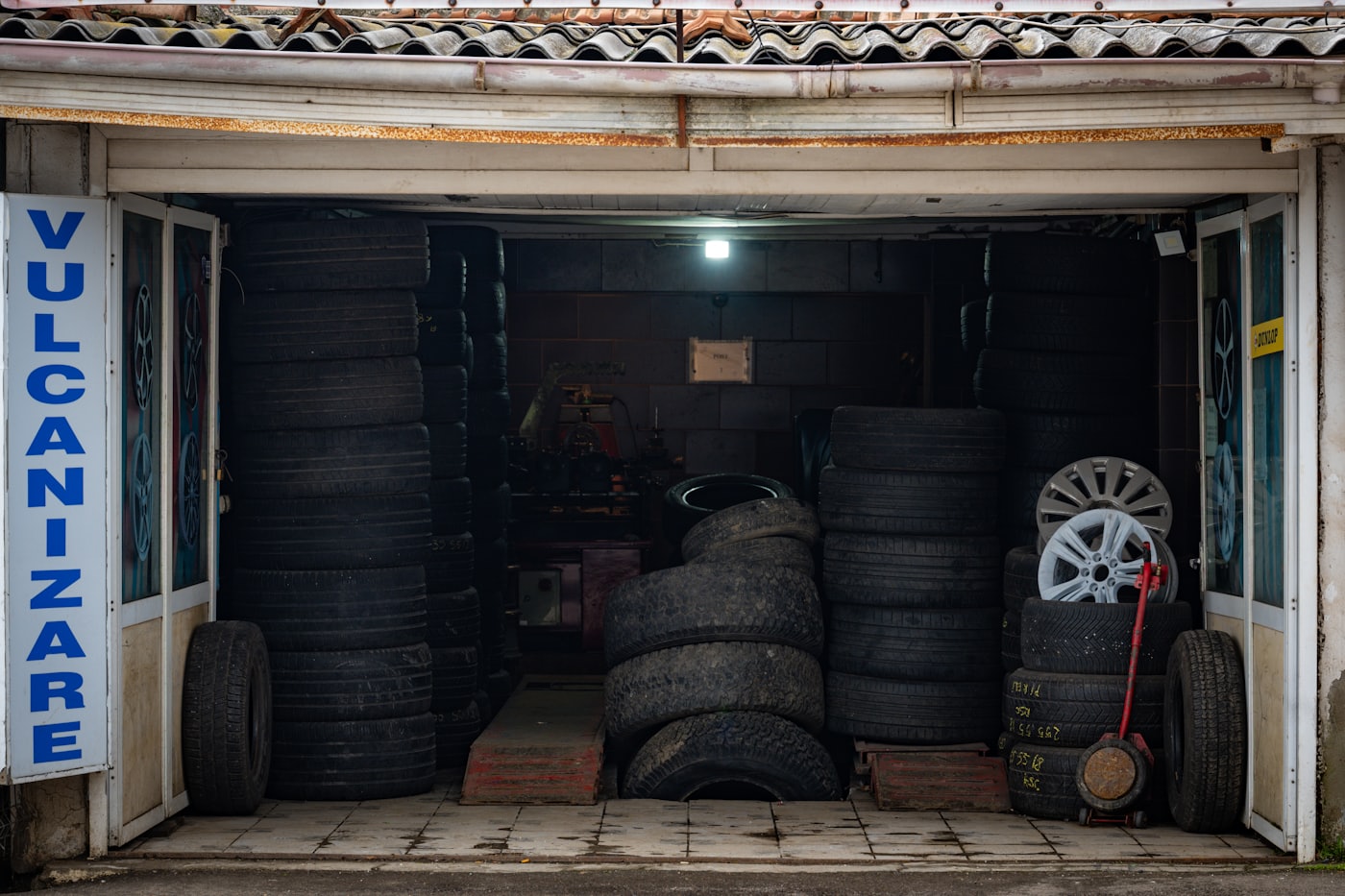 Tire shop interior with stacks of tires and rims